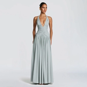 Detailed view of the pleated waist and flowing mint green halter neck maxi dress