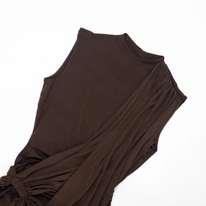 Detail of dark brown sleeveless dress showing side draping and ruching texture