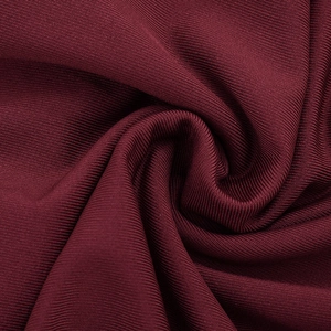 Close-up of deep red ribbed knit fabric texture showing fine vertical stitching detail