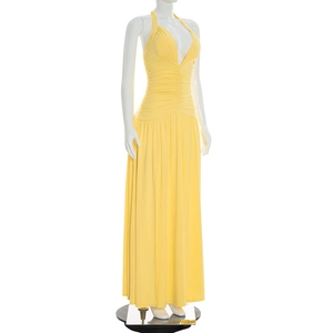 Detail of the yellow halter V-neck maxi dress with elegant pleats and slim fit silhouette