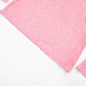 Detail of pink floral lace fabric showing delicate hollow patterns on the summer beach dress