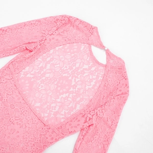 Detail of pink floral lace dress featuring back teardrop cutout and button closure