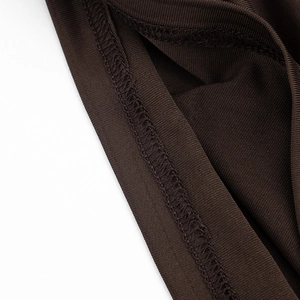 Close-up detail of dark brown ribbed knit fabric showing professional overlock stitching
