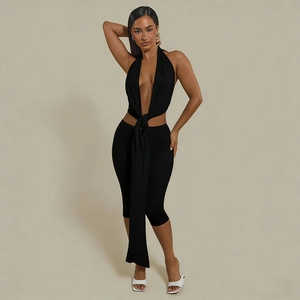 Detail of black halter neck top with knot design and matching cropped slim leggings