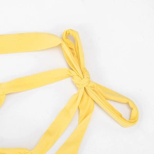 Close-up of bright yellow halter neck ties with fine stitching and elastic fabric