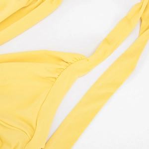 Detail of elegant yellow V-neck halter dress featuring delicate gathering and long ties