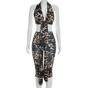 Detail view of leopard print two-piece set featuring a halter crop top with long streamers