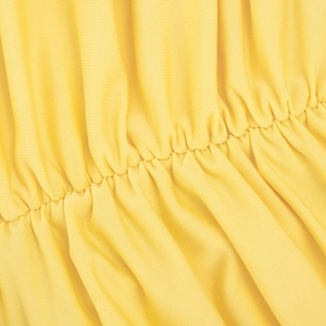 Detailed close-up of yellow ribbed fabric texture and ruched seam craftsmanship