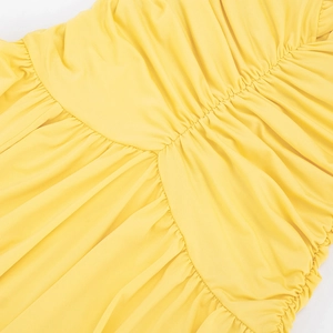 Detailed view of the yellow ruched fabric and pleat texture on the sleeveless summer dress