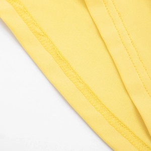 Detail of high-quality reinforced double-stitching on elegant yellow dress fabric
