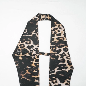 Detail view of the leopard print halter neckline and stretchy polyester blend fabric
