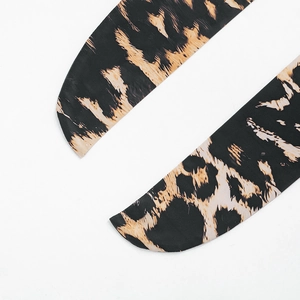 Detail of leopard print fabric strap with refined stitching and smooth texture