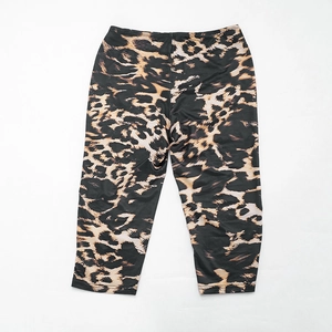 Detailed flat lay of leopard print slim-fit cropped leggings with elastic waist on white
