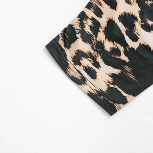 Detailed macro view of the leopard print fabric with precise double-needle stitching quality