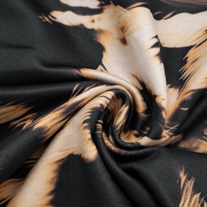 Macro detail of elastic leopard print knit fabric with soft texture and vibrant finish