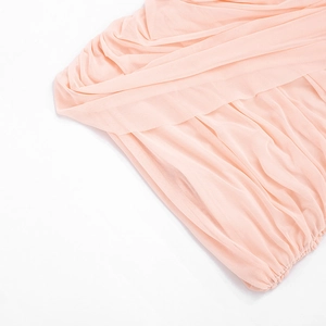 Detail of light pink sleeveless dress featuring delicate pleated chiffon fabric and smocked edge