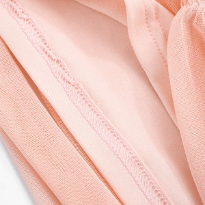 Detail view showing professional stitching and mesh fabric layers on a pink mini dress