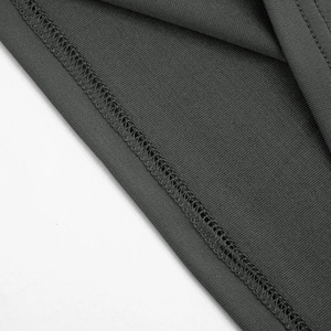 Detailed macro view of the reinforced overlock stitching on a dark grey knit mini dress