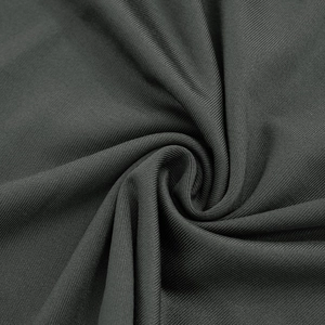 Detailed macro shot of dark grey ribbed knit fabric showing soft texture and premium quality