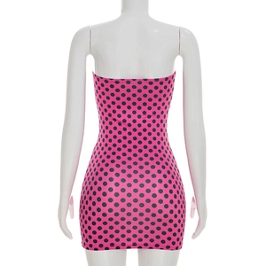 Rear view of a tight fuchsia bodycon dress with black polka dots on a mannequin