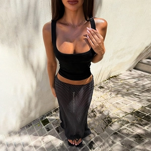 Modern look featuring a black ribbed tank top paired with a polka dot maxi straight skirt