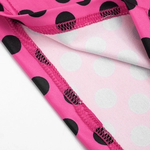 Close-up of pink polka dot dress showing high-quality stitching and fabric texture