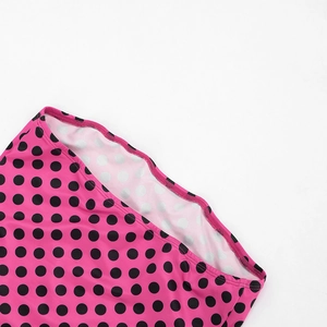 Detail view of pink polka dot dress with high-quality stitching and elastic fabric texture