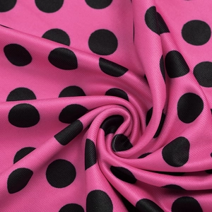 Close-up of pink polka dot silk fabric texture on sexy bodycon mini dress