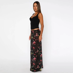 Detailed view of women's summer long chiffon skirt with red and pink floral prints