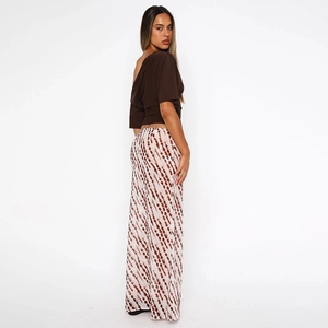 Side view of long high waist brown skirt with vertical stripes and asymmetrical top