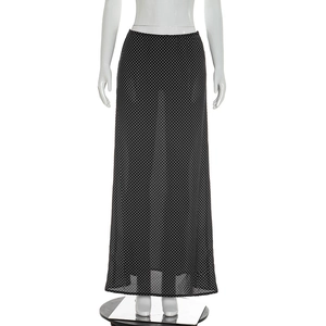Detailed macro view of the sheer hemline on this black and white polka dot chiffon skirt
