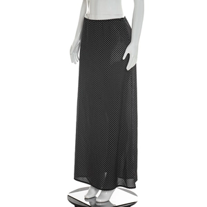 Detailed texture of black chiffon maxi skirt with white polka dot digital print pattern