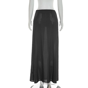 Detailed view of the chiffon fabric texture with white polka dots on a black maxi skirt