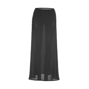 Detailed view of lightweight black chiffon maxi skirt featuring white polka dot patterns