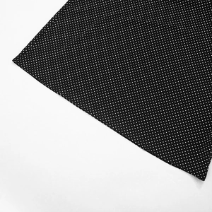 Detail shot of the white polka dot print on premium black chiffon fabric material