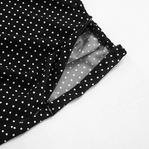 Detail of hidden zipper and black polka dot pattern on chiffon long straight skirt