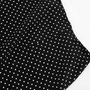 Macro detail of high-quality polka dot chiffon fabric with precise seam stitching