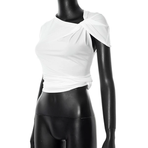 Detail of white slim fit cropped top featuring asymmetric shoulder twist knot design