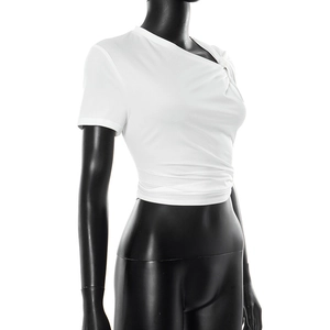 Detail of white crop top with asymmetric neckline and unique knot detail on the shoulder