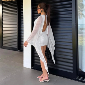 Detail of the open back and flowing cape sleeves on the white polka dot dress