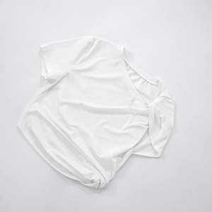 Close-up of white cropped t-shirt showing soft cotton fabric and round neckline detail