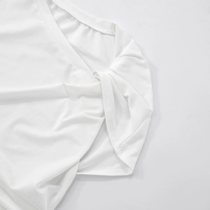 Close-up of side seam and stitching detail on a white sleeveless knit crop top