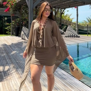 Brown bodycon dress with mesh cape and polka dot print for a summer resort style