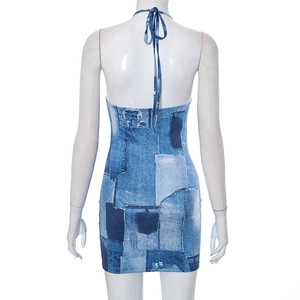 Detail of the backless halter design and denim patchwork print on the mini bodycon dress