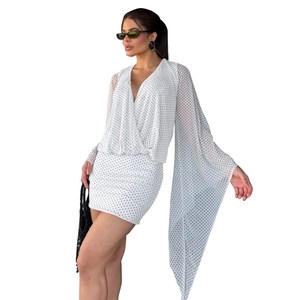 White polka dot mini dress with deep V-neck and dramatic long slit flared sleeves