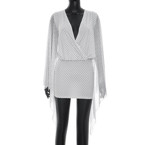 Detailed view of polka dot mesh dress with cape sleeves and open back design