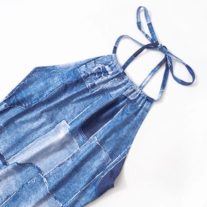 Detail of blue denim print halter dress showing the neck tie and distressed pattern