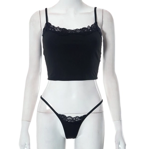 Close-up of black ribbed crop top and thong set featuring delicate lace trim details