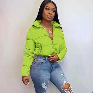 Detail view of the bright green puffer jacket showing the zipper and quilted texture
