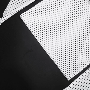 Detailed close-up showing white polka dot fabric and high-quality stitching on dress
